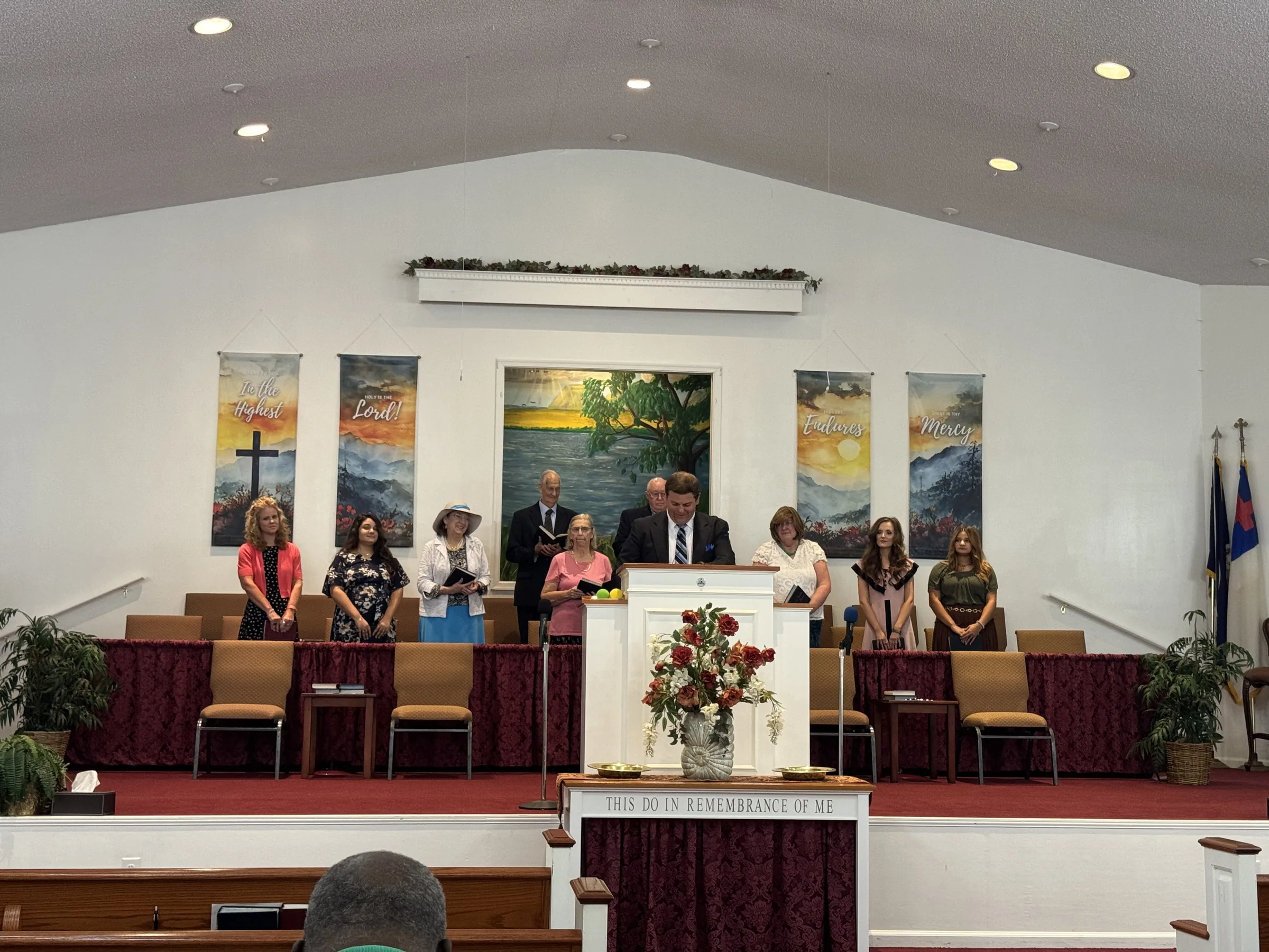 The church choir stands together at the front of the Grace sanctuary